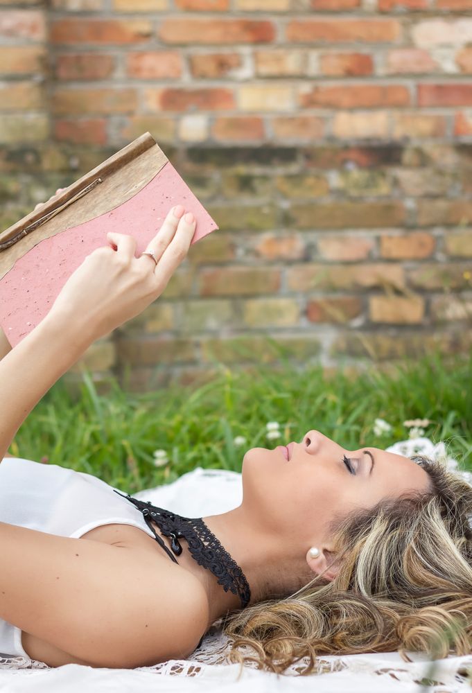 woman with book on the grass