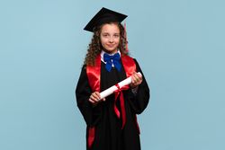 Young girl in graduation attire holding diploma