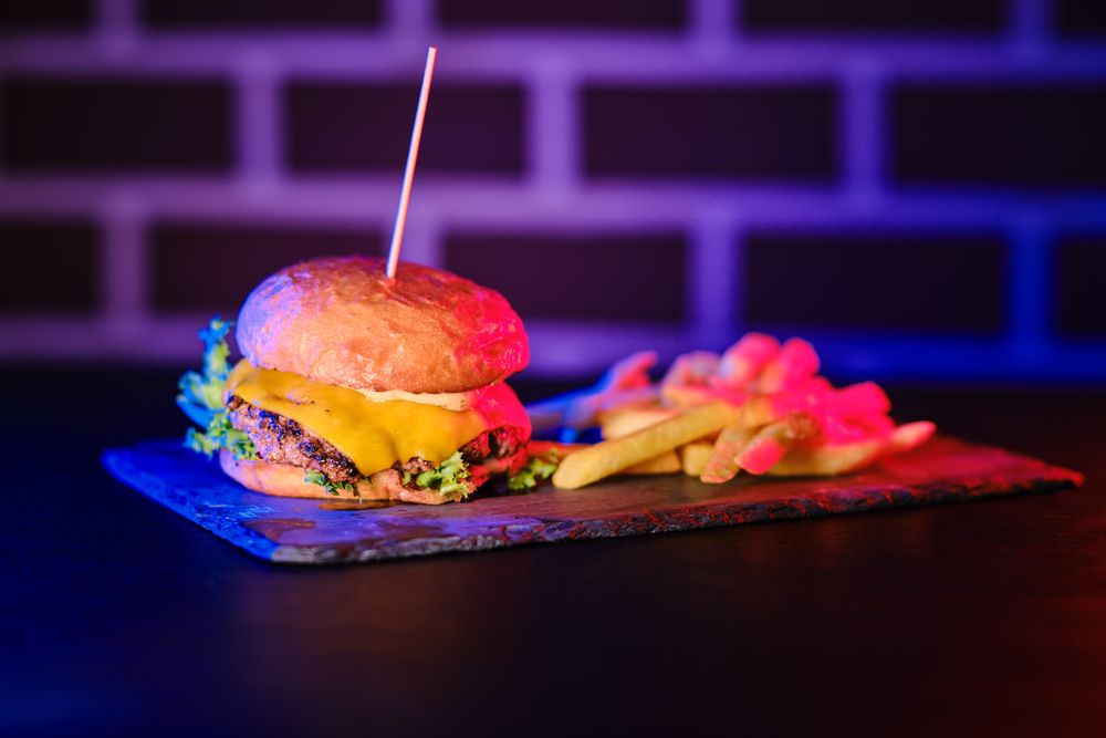 Delicious hamburger and fried potato on board