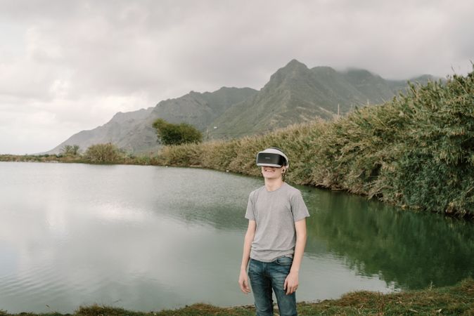 Young teenager with virtual reality glasses outdoors