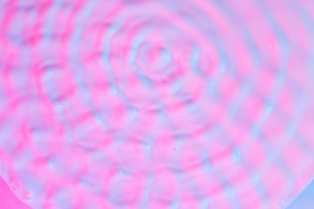 Ripples lit with vibrant bold gradient holographic colors
