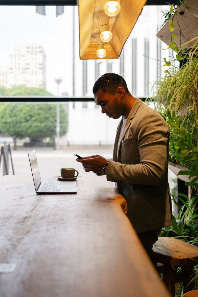 Man working on laptop at cafeteria
