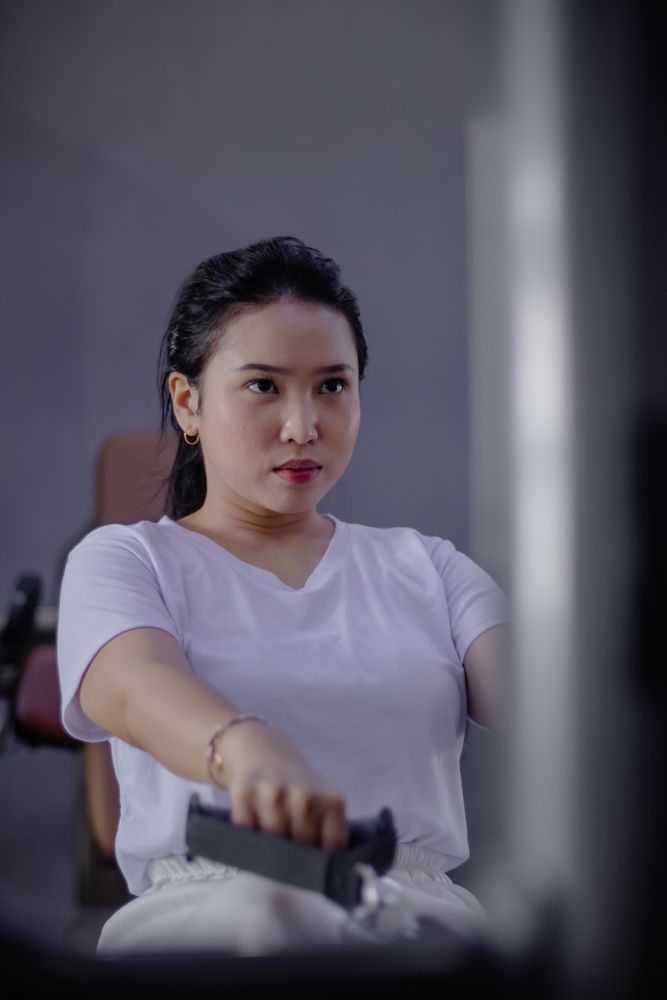 Focused Athlete Doing Rowing Exercise in the Gym Studio Center