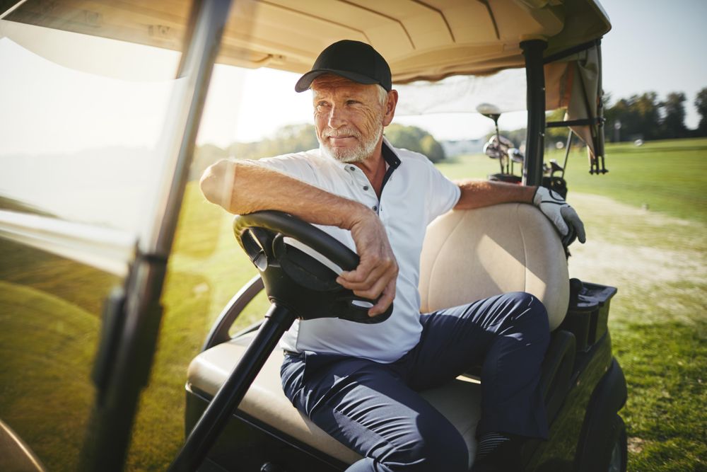 Man sitting in golf cart on court