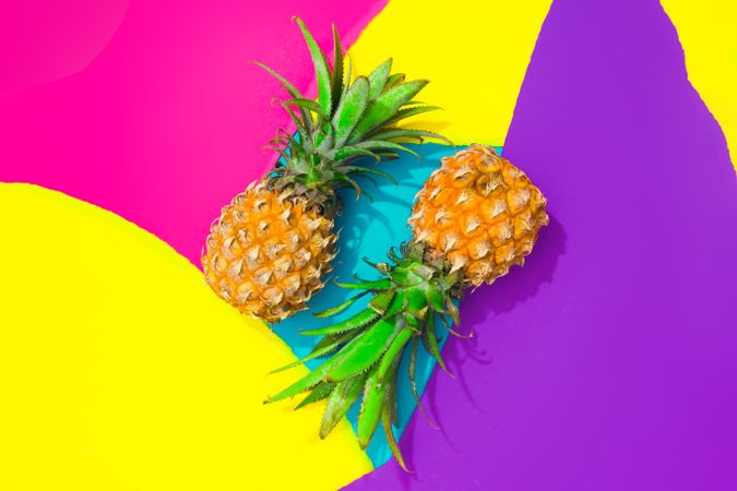 Pineapples on pattern of ripped paper in vivid colors