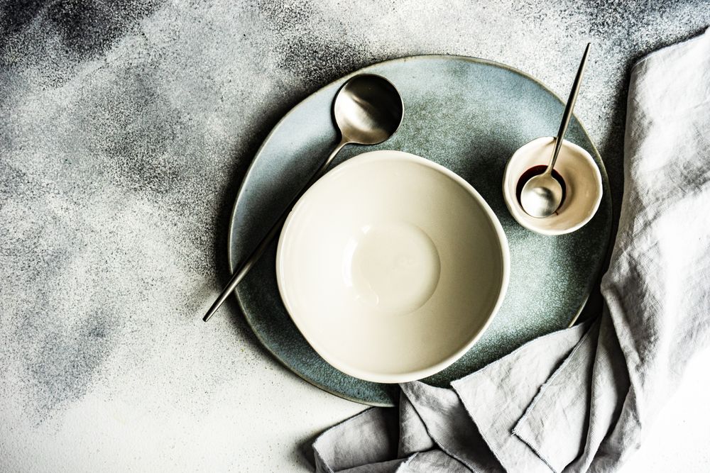 Top view of chic cutlery set with bowl and spoon