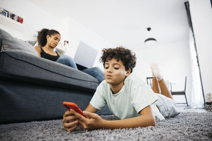 Mother and her daughter sitting on sofa