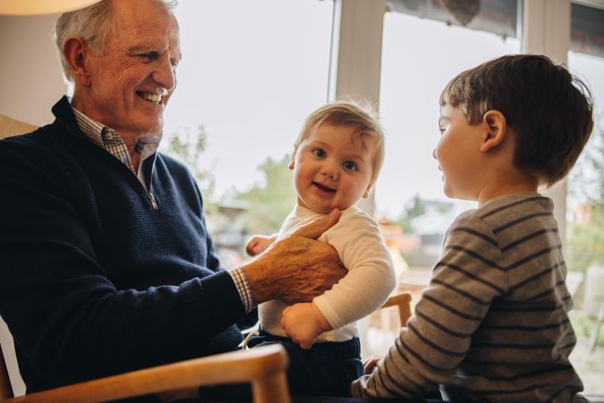 Grandfather enjoying time with his grandsons at home