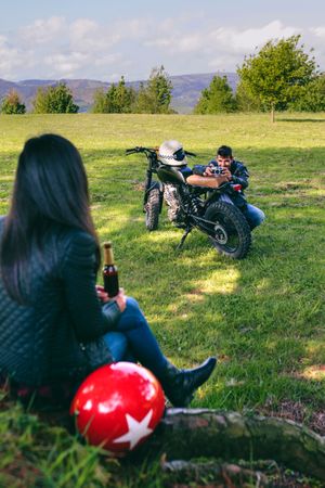 Couple resting from a motorcycle trip taking picture