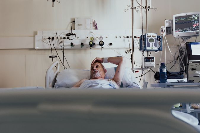 Older man admitted to a hospital room.