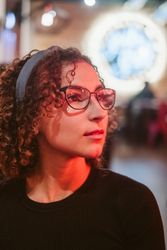 Dreamy woman in glasses looking away