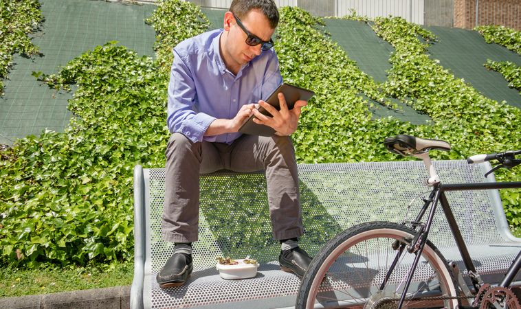 Young business man working with electronic tablet in lunch break