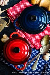 Top view of two red & blue cast iron pan on counter with kitchen towels ingredients 5lVmkM
