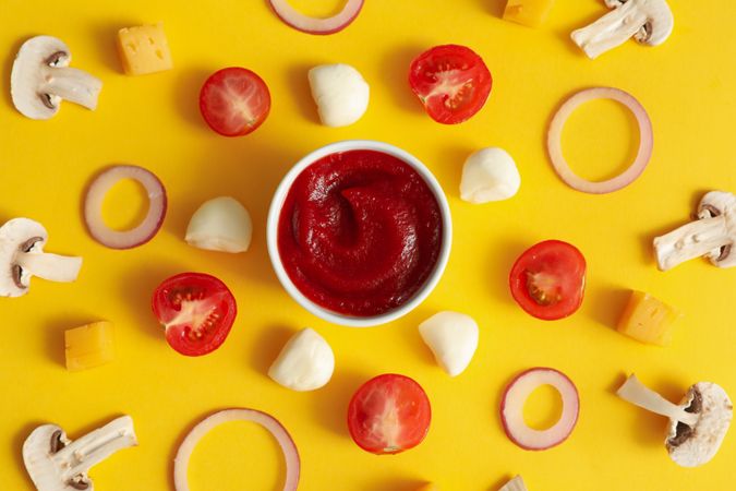 Ingredients for cooking pizza on yellow background