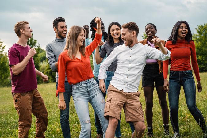 Multicultural friends enjoying a dance outdoors