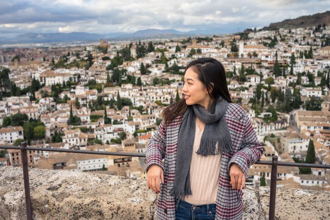 Cheerful woman visiting ancient city