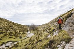 Man walking on hill near valley