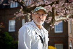 Portrait of smiling male with grey beard with cherry blossom tree