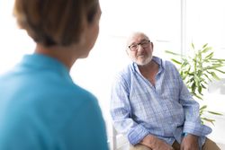 A mature man in a physiotherapy clinic with female physiotherapist