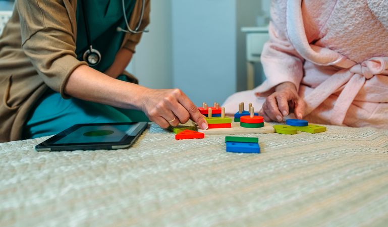 Female doctor showing geometric shapes to patient