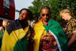 London, England, United Kingdom - August 27, 2022: Two male friends dropped in flags in Notting Hill