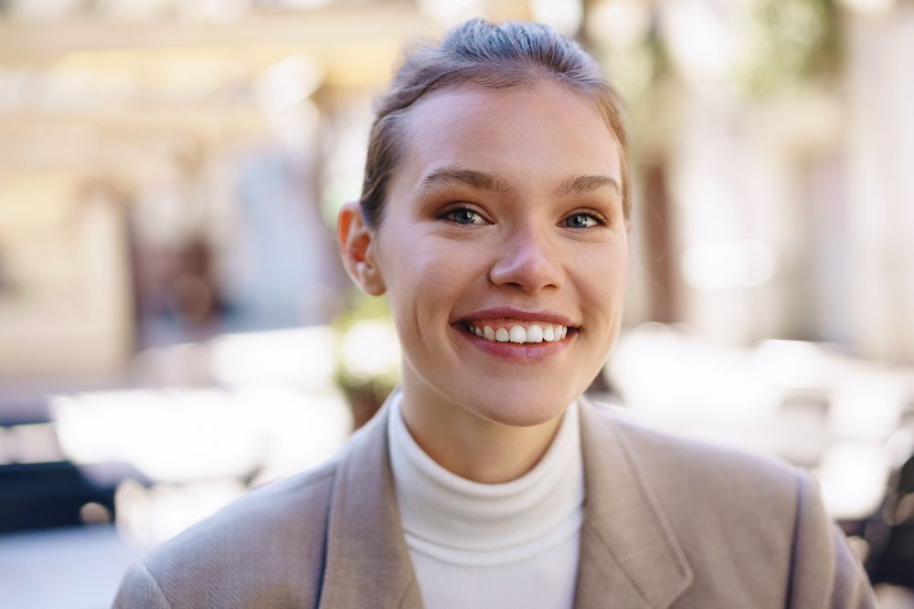 A Smiling Young Woman in a Stylish and Chic Setting That Exudes Confidence and Charm