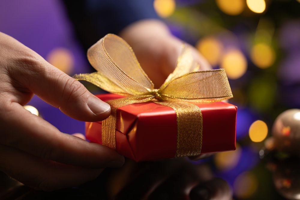 Businessman Holding Gift Christmas Tree
