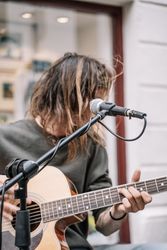 Faceless male musician performing in the street