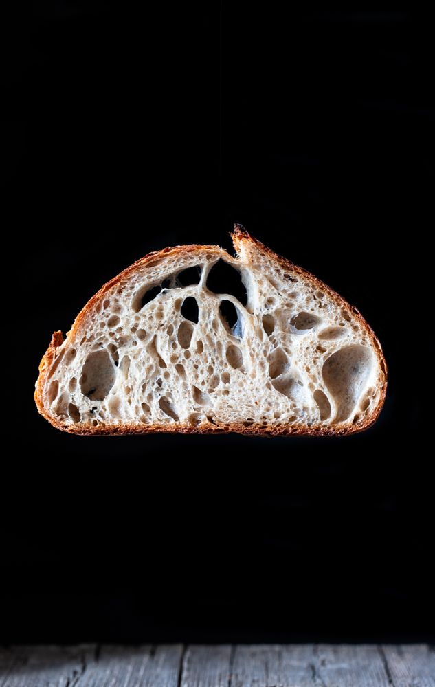 Slices of fresh bread falling on table