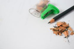 Pencil on table with shavings & sharpener with space for text