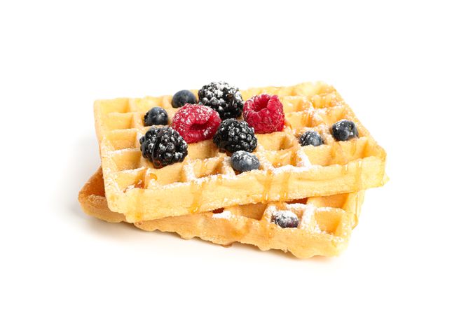 Waffles with caramel topping isolated on blank background