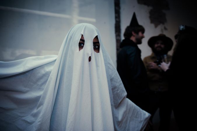 Portrait of a person in ghost costume at Halloween party