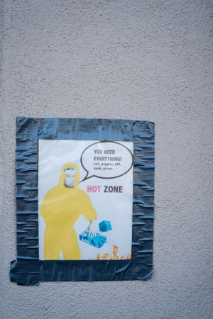 Handmade sign with graphic of The Rock taped on wall at public pandemic testing site
