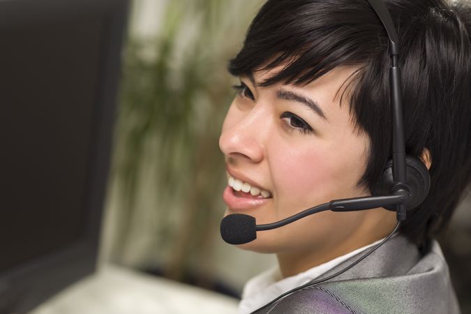 Young Woman Smiles Wearing Headset