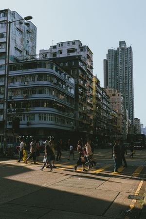 People walking on pedestrian lane near high rise buildings during daytime