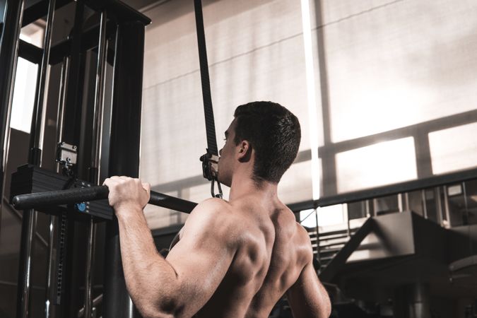 Young fitness man training in gym