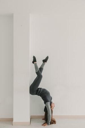 Flexible female training upside down in studio