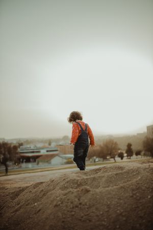 Young girl walking down a small hill