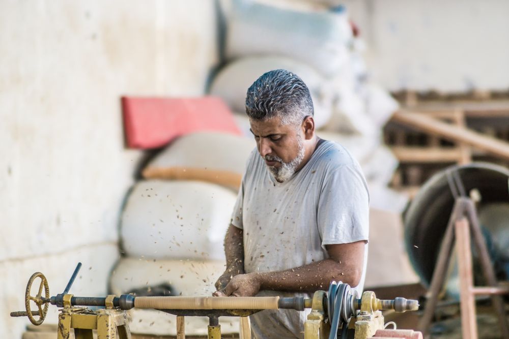 Man using woodworking machine at workplace