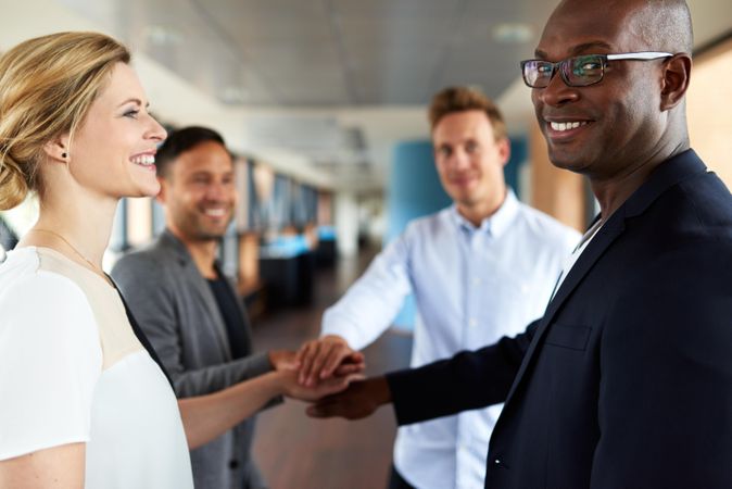 Smiling business colleagues with their hands together