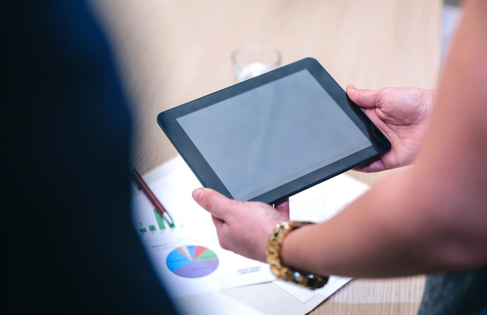 Unrecognizable woman holding blank tablet in business meeting