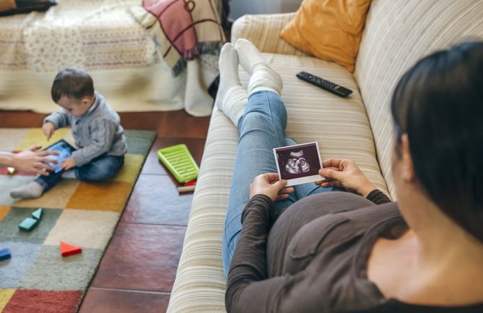 Pregnant looking at ultrasound of their new baby