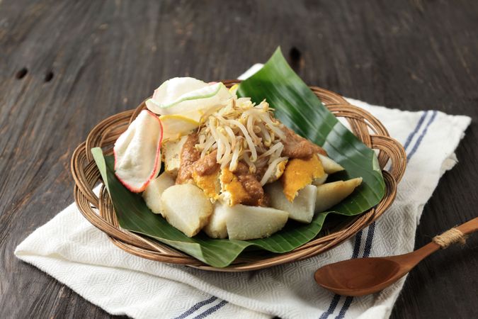 Kupat Tahu, Compressed Rice Cake Served with Yellow Tofu, Sprout, Spicy Peanut Sauce, and Kerupuk