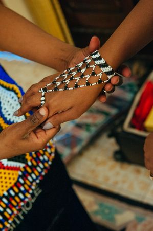 Hand wearing a beaded Zulu bracelet