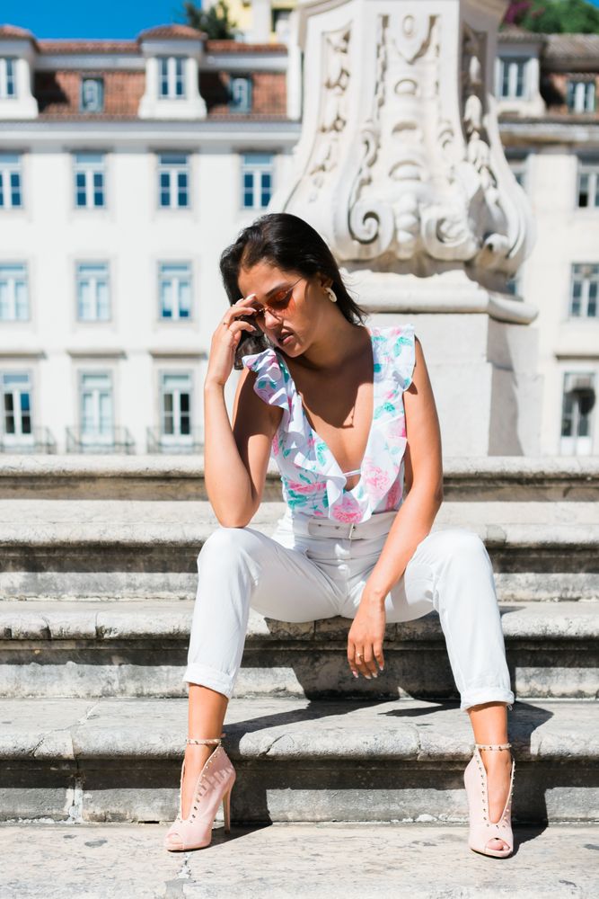 stylish woman in sunglasses sitting in street stairs