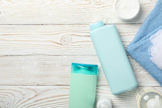 Composition with body care products on wooden background, top view