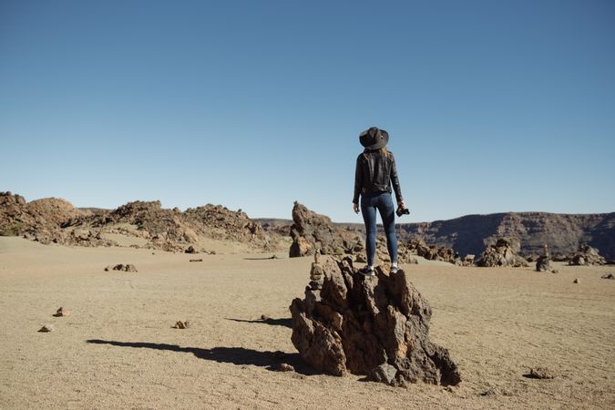 Tourist standing on top of rock