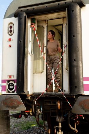 Military woman standing inside railway wagon