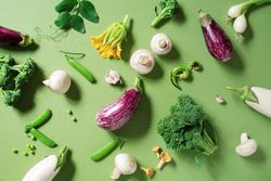 Top view of fresh raw vegetables on green table