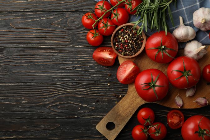Composition with tomatoes on wooden background. Ripe vegetable